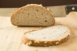 Wholemeal bread with rolled oats, partly sliced