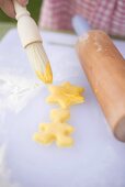 Brushing biscuits with egg yolk