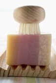 Soap and brush on wooden soap dish