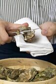 Man opening a fresh oyster