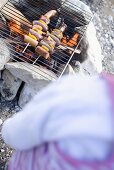 Sausage and pepper kebabs on barbecue