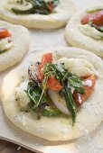 Focaccia topped with vegetables and basil