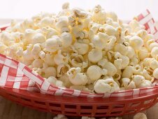 Popcorn auf Serviette in rotem Plastikkorb