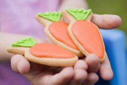 Child's hands holding Easter biscuits