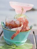 Shrimps with dip, cocktail in background