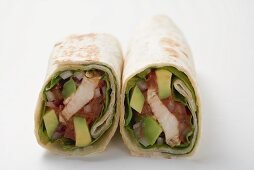Two wraps filled with chicken and avocado