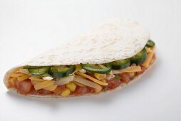 Tortilla filled with salsa, chillies and cheese
