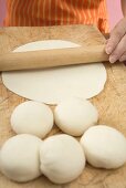 Woman rolling out tortilla dough