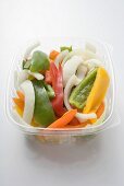 Sliced vegetables in opened plastic container