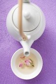 Teapot and bowl of rose tea