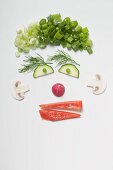 Amusing face made from vegetables, dill and mushrooms