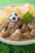 Zürcher Geschnetzeltes (veal dish) with pasta, football & fork