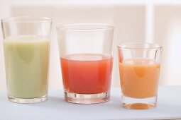 Three different juices in glasses, side by side