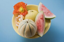 Three different melons in bowl (overhead view)