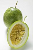 Green passion fruits, whole and half