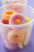 Sugar rings and other sweets in plastic tubs