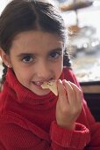 Girl eating Christmas biscuit