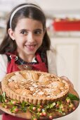 Girl holding freshly-baked apple tart