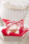 Woman holding box of Christmas biscuits