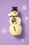 Chocolate snowman, surrounded by paper snowflakes