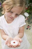 Small girl holding a jam biscuit