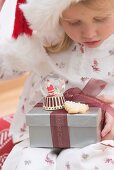 Small girl holding Christmas gifts