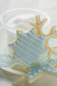 Christmas biscuits in front of glass of milk foam