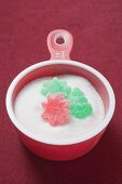 Jelly sweets and sugar in measuring cup (Christmas)