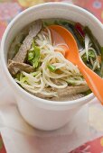 Asian noodle soup with beef in polystyrene cup
