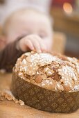 Baby reaching for almond cake