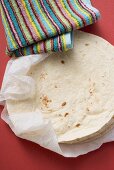 Freshly-baked tortillas on kitchen roll (Mexico)