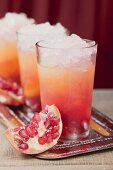 Three fruity drinks with orange juice & pomegranate