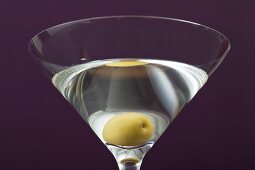 Martini with olive in glass