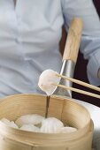 Cooking dim sum in bamboo steamer