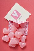 Pink heart-shaped sweets and Valentine card
