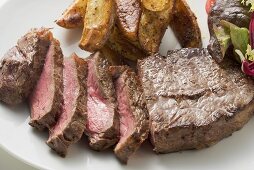 Beef steak with potato wedges and salad