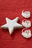 Cinnamon star and Father Christmases on red felt