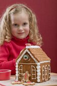 Small girl with gingerbread house
