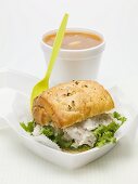 Chicken salad sandwich in polystyrene container, tomato soup
