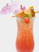 Cocktail with exotic fruit skewer and umbrella