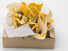 Tortilla chips with cheese, olives and onions to take away