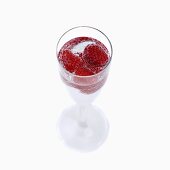 Mineral water and raspberries in stemmed glass