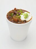 Chili con carne with sour cream in polystyrene cup