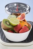 Bowl of fresh fruit on scales