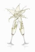 Clinking glasses of sparkling wine (with star-shaped splash)