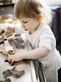 Little girl baking biscuits