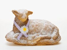 Baked Easter lamb with icing sugar and ribbon