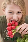 Woman biting a radish