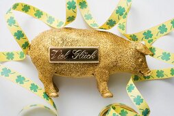 Golden pig with bow for New Year (good luck charm)