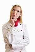 Thoughtful blond female chef in work clothes
